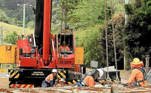 Workers were putting the last of the girders in place on the bridge upgrade on Syndicate Rd.